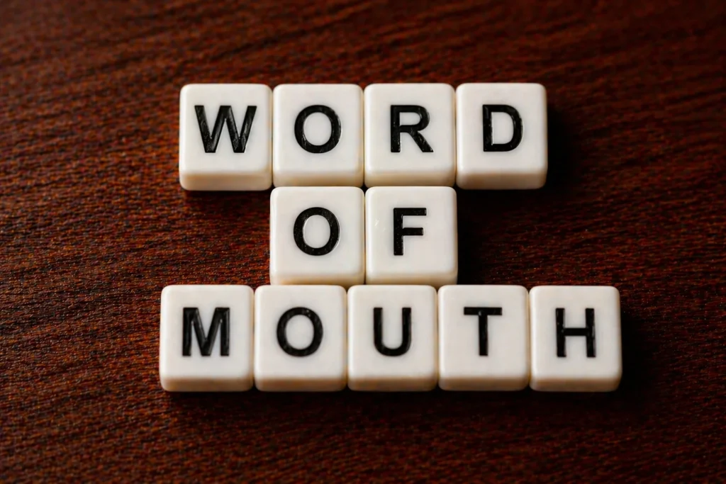 Letter cubes spelling Word of Mouth representing loyalty program referral marketing