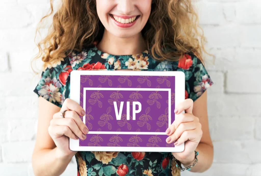 A happy customer holding a tablet displaying a VIP loyalty membership program