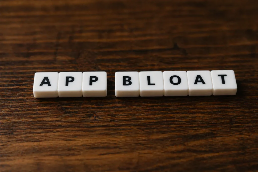 Letter tiles spelling App Bloat representing the definition of App Bloat in Shopify stores